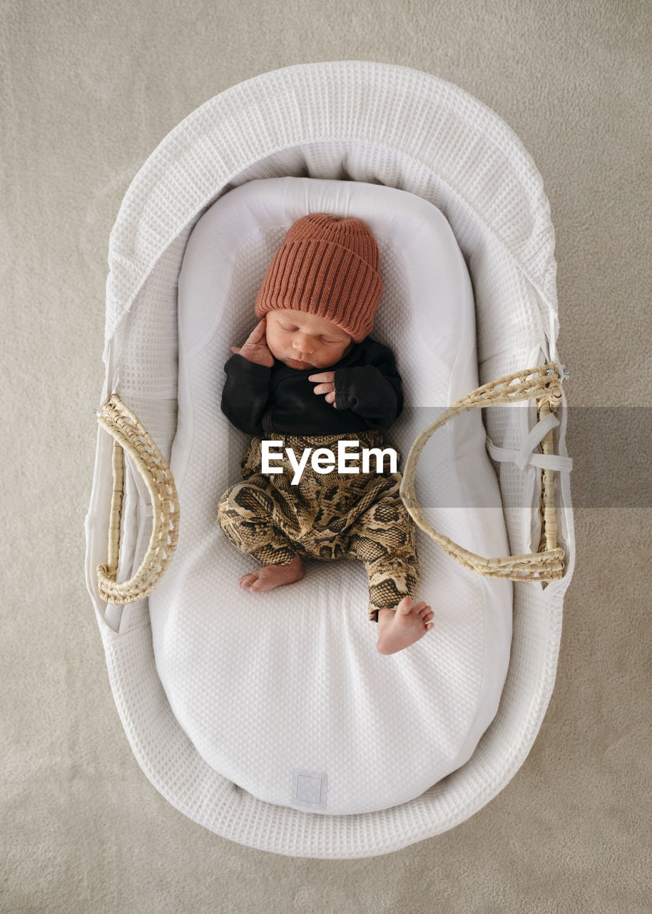 Newborn baby boy sleeping in cot