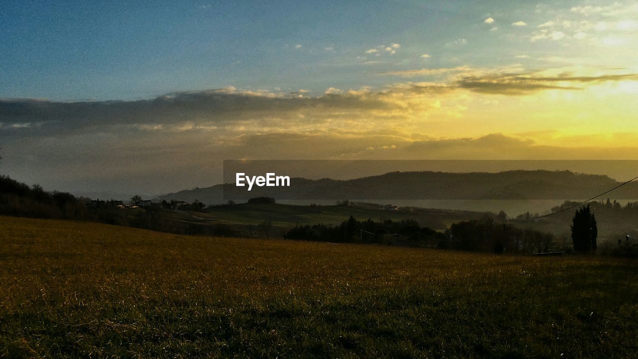 Scenic view of landscape and mountains during sunset