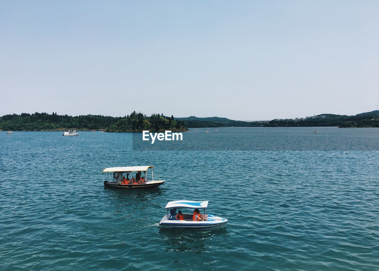 BOATS SAILING IN SEA