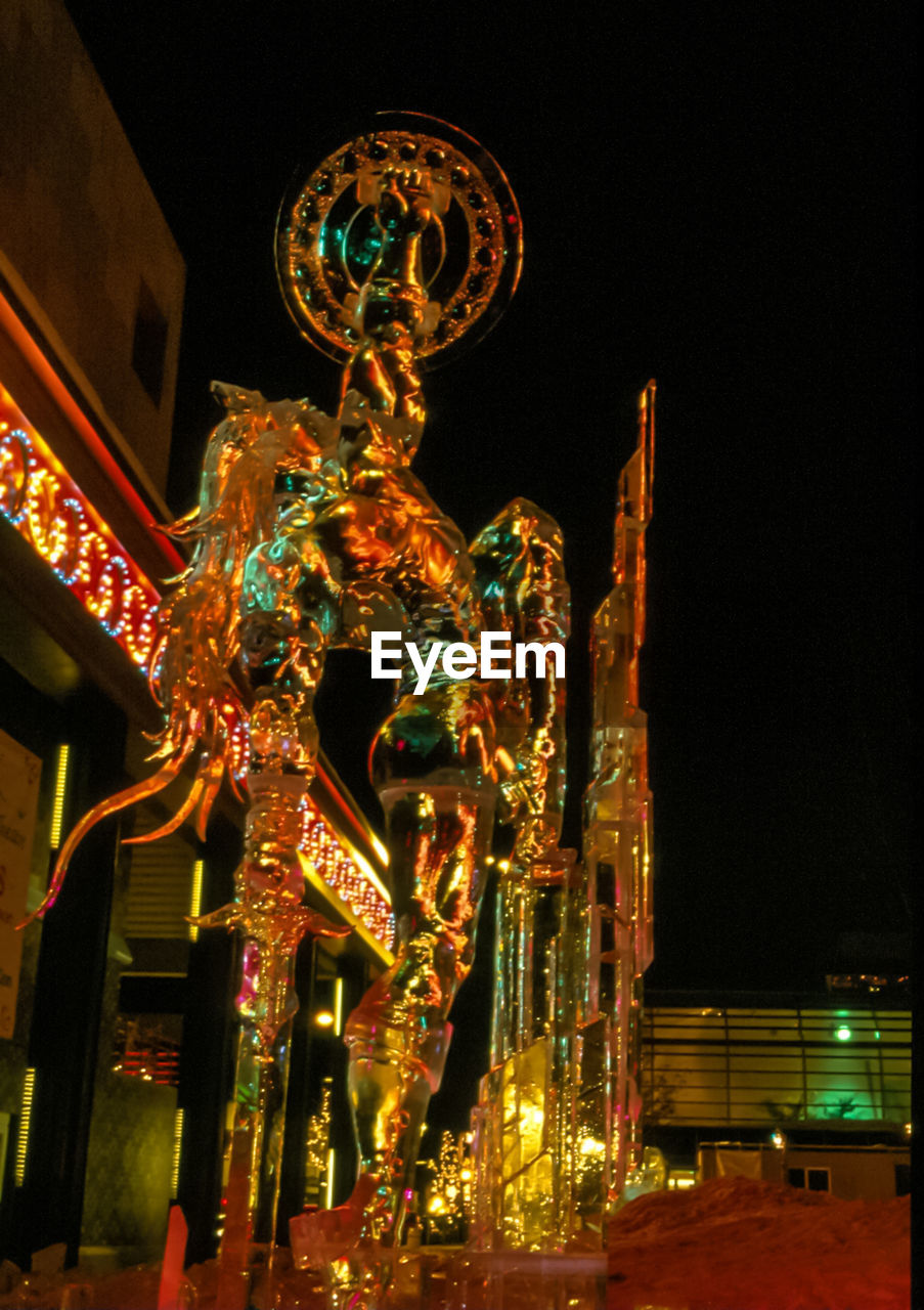 LOW ANGLE VIEW OF ILLUMINATED LIGHTS AT NIGHT