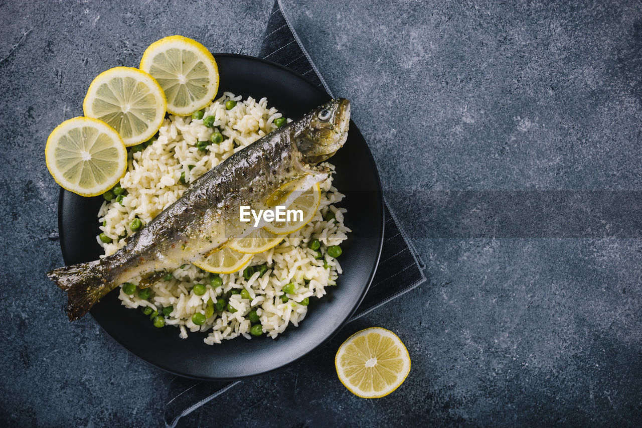 Delicious roasted trout seasoned with spices and lemon juice with rice