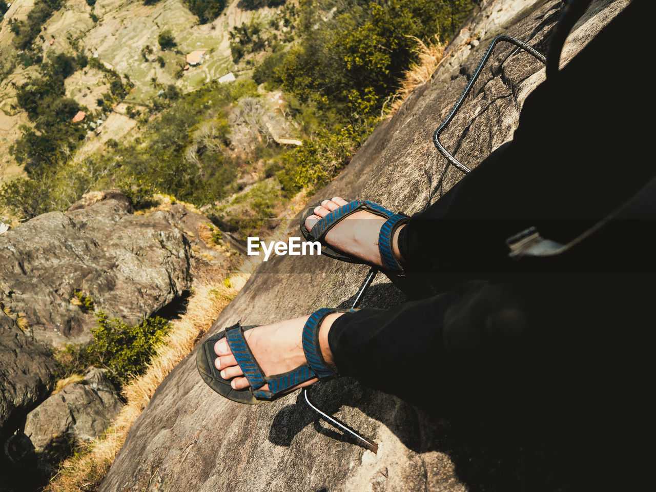 Low section of man standing on rock formation