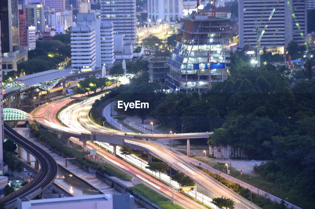 HIGH ANGLE VIEW OF LIGHT TRAILS ON ROAD