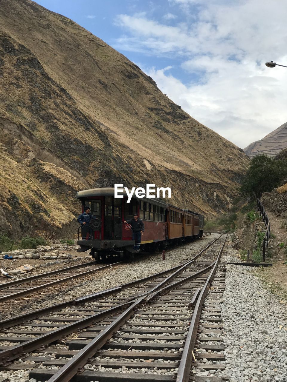 TRAIN IN RAILROAD TRACKS AGAINST SKY