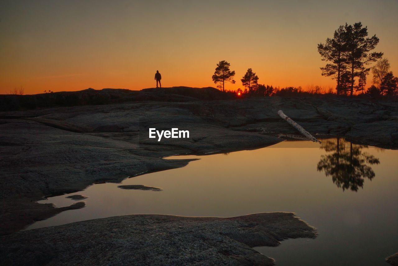 Scenic view of lake against sky during sunset