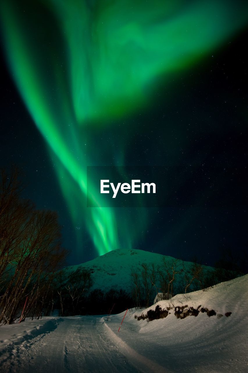 Scenic view of snowcapped landscape against sky at night