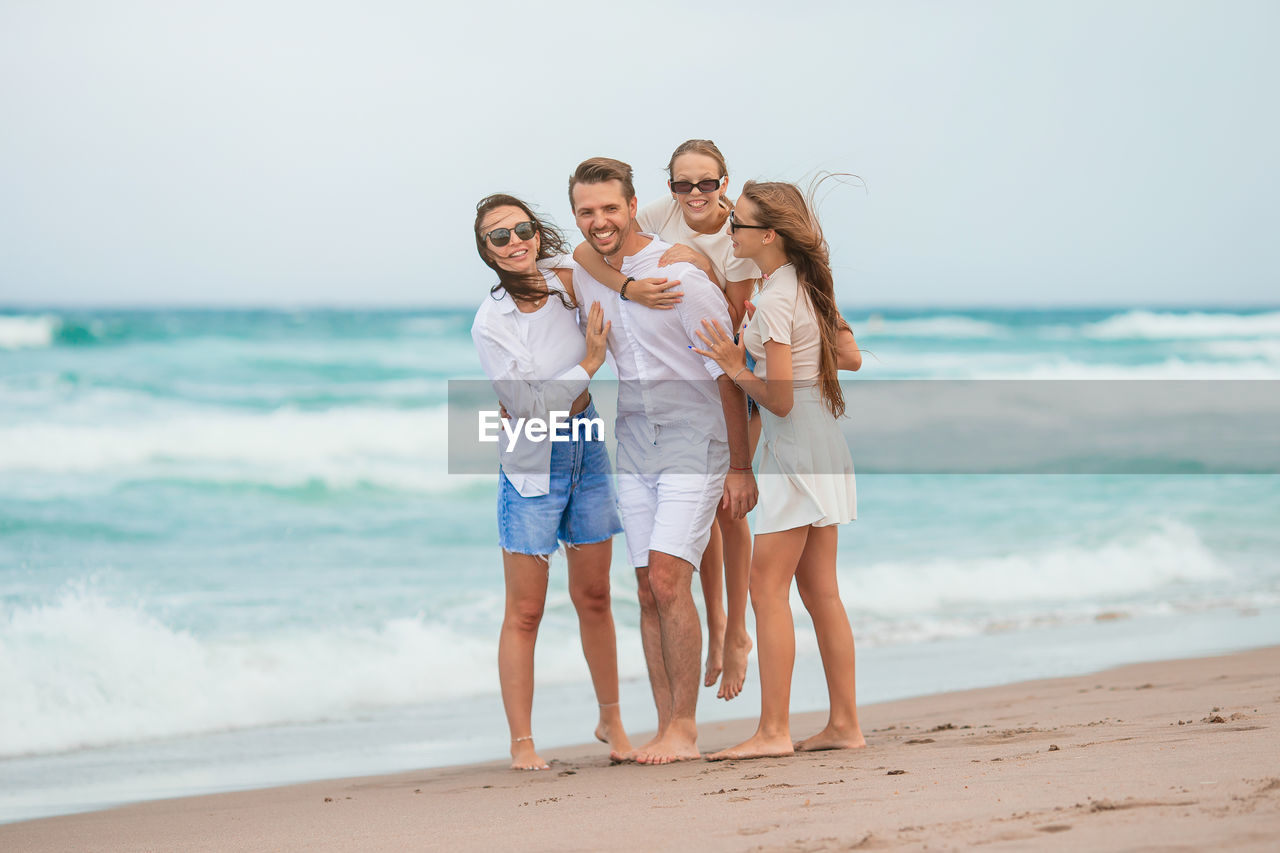 rear view of couple standing at beach