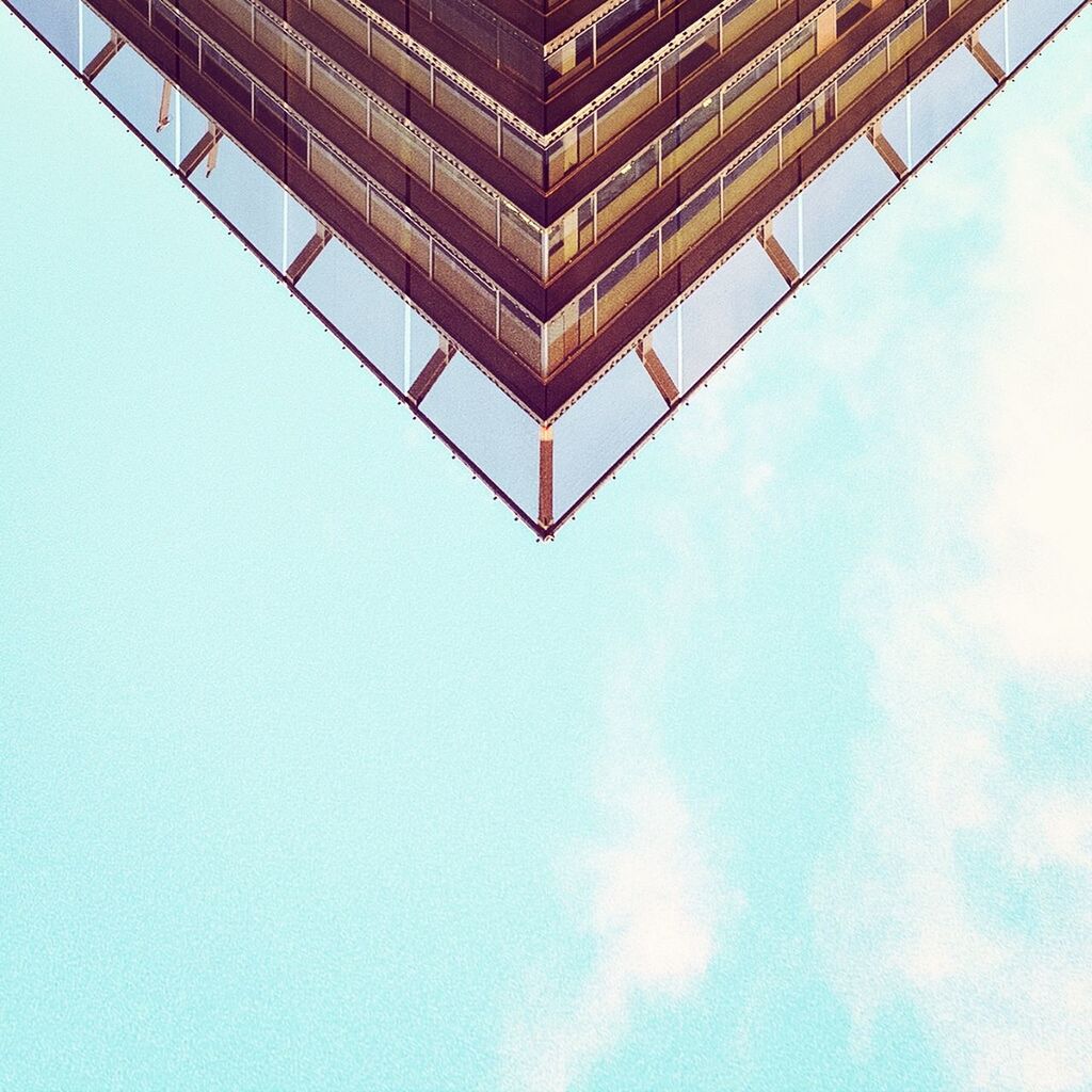 LOW ANGLE VIEW OF BUILT STRUCTURE AGAINST BLUE SKY AND CLOUDS