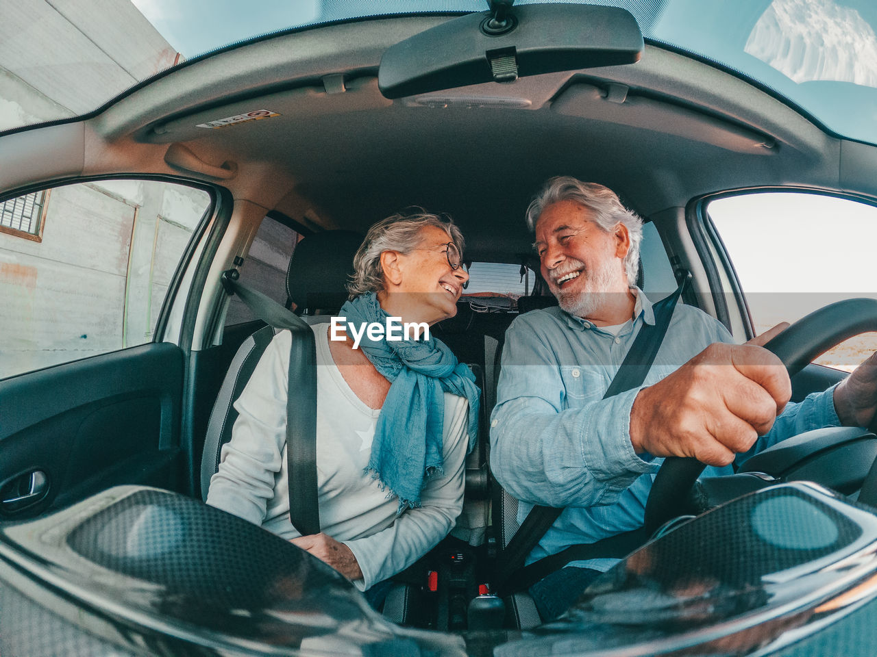 Portrait of smiling couple sitting in car