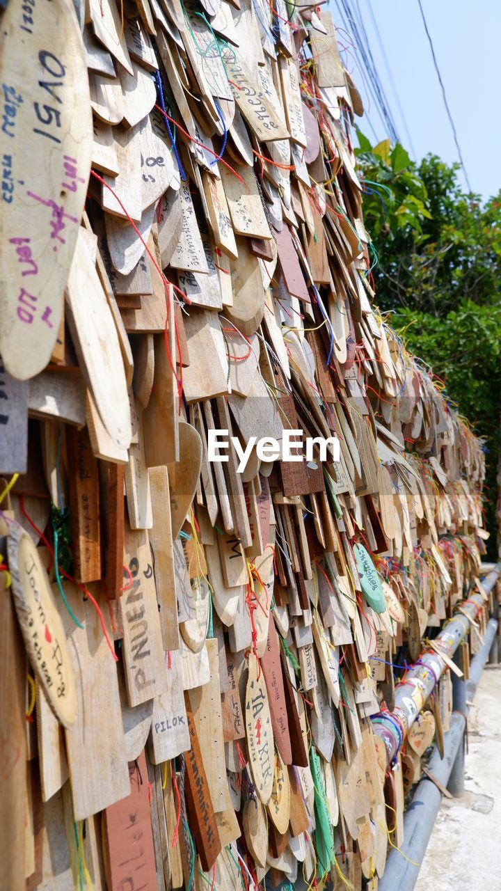 CLOSE-UP OF CLOTHES HANGING ON WOODEN POST