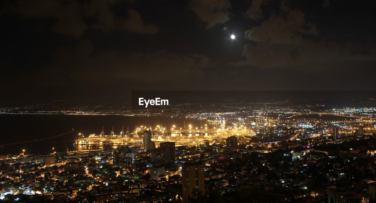 Illuminated cityscape against sky at night