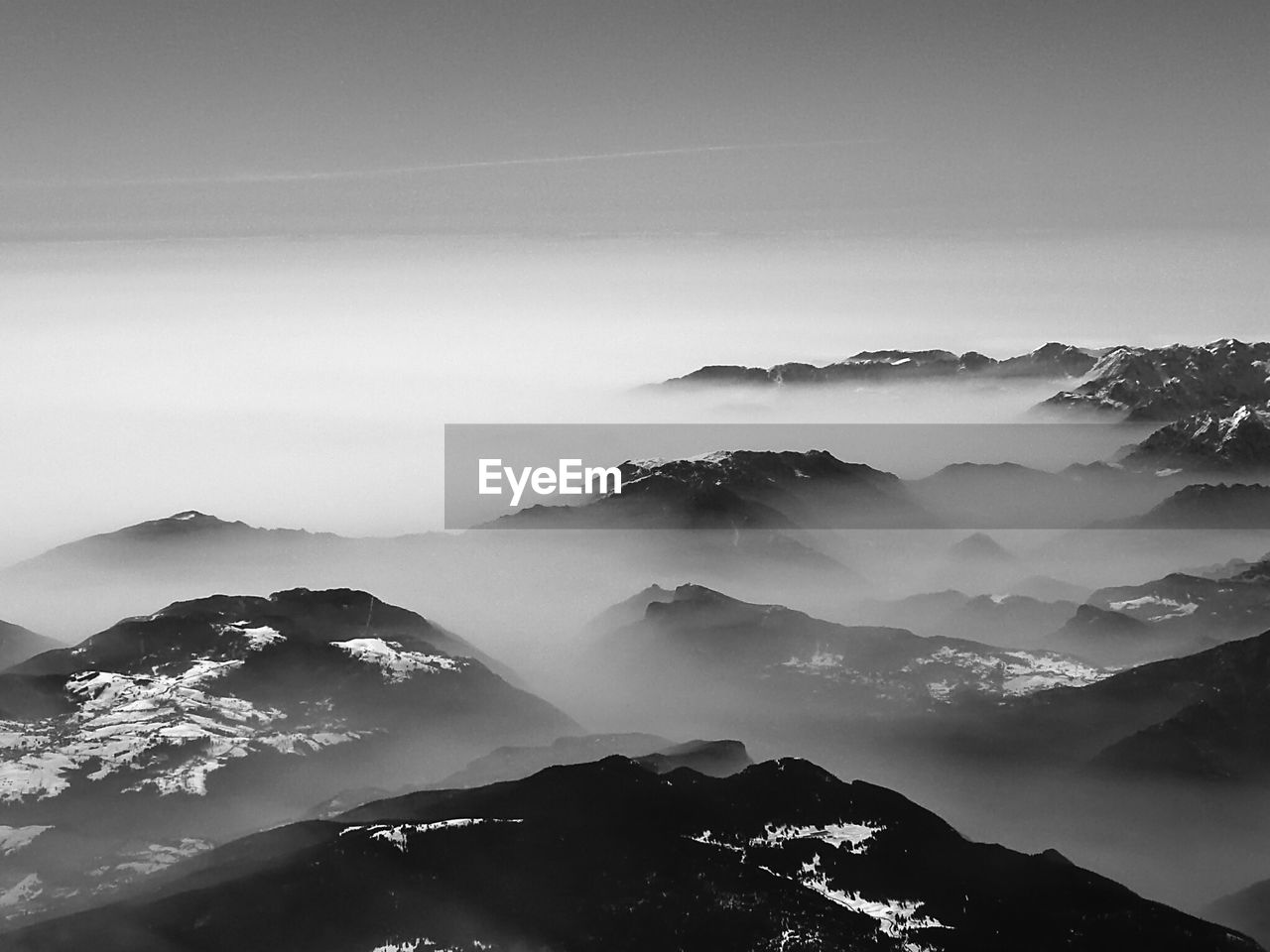 Scenic view of alps mountains in foggy weather