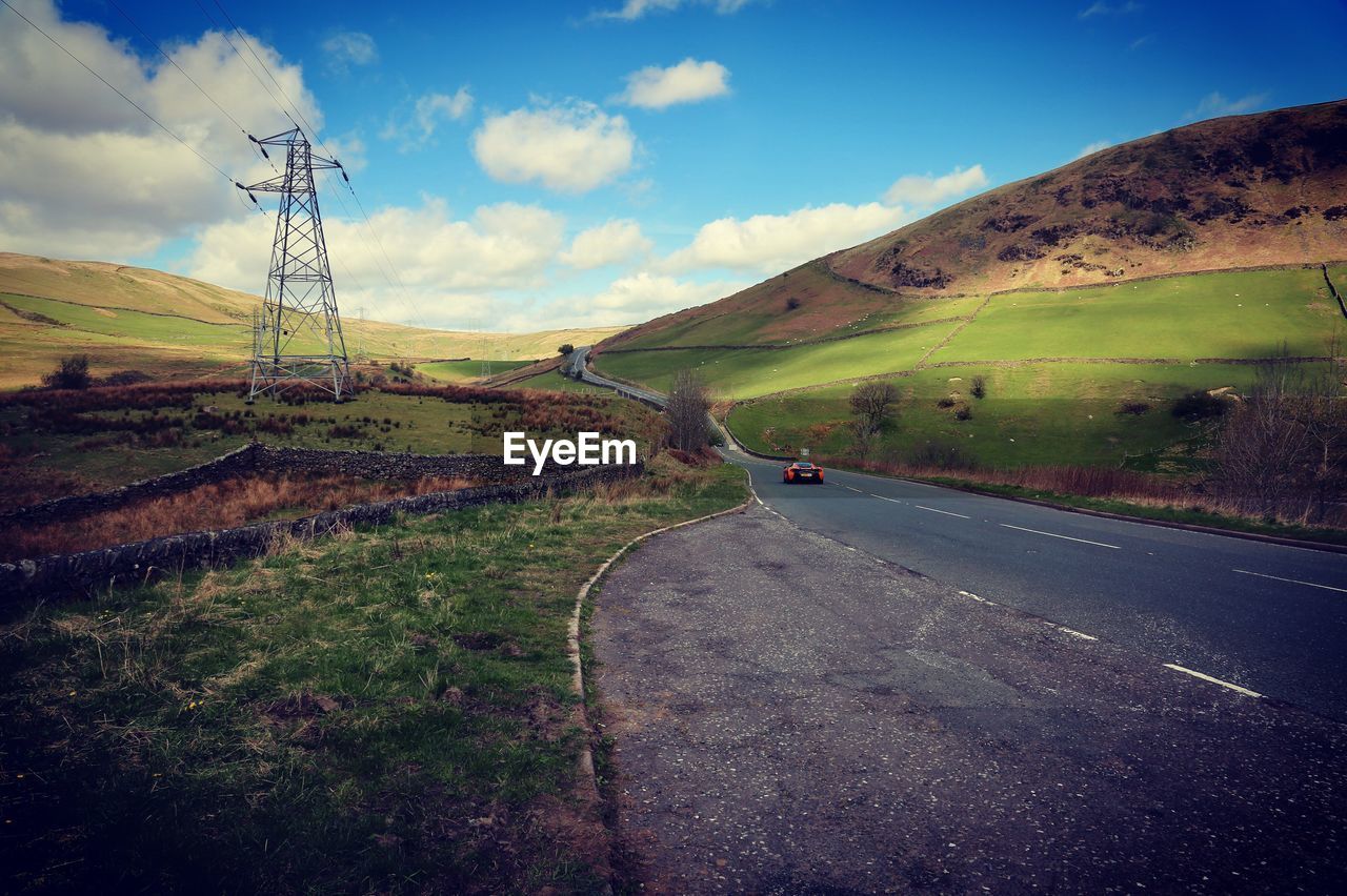 ROAD BY MOUNTAIN AGAINST SKY