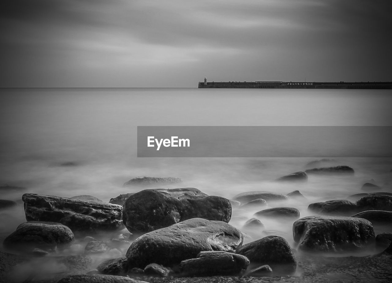 Scenic view of sea against cloudy sky