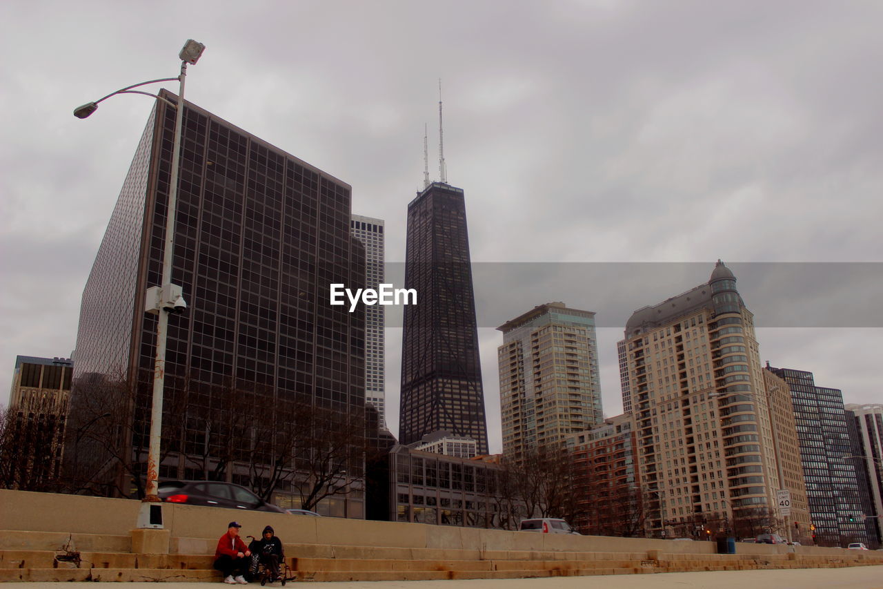 SKYSCRAPERS AGAINST CLOUDY SKY