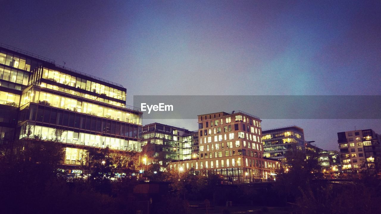 Low angle view of illuminated building against sky at night