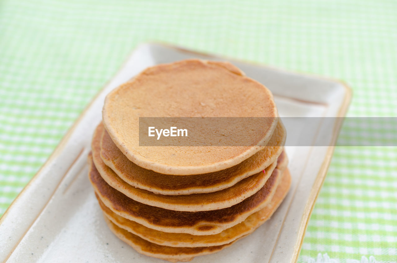 Close-up of pancakes in plate on table