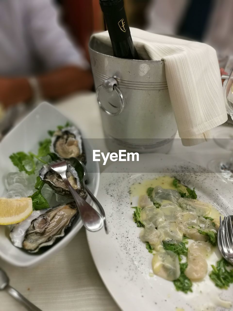 Seafood with wine bottle on table at restaurant