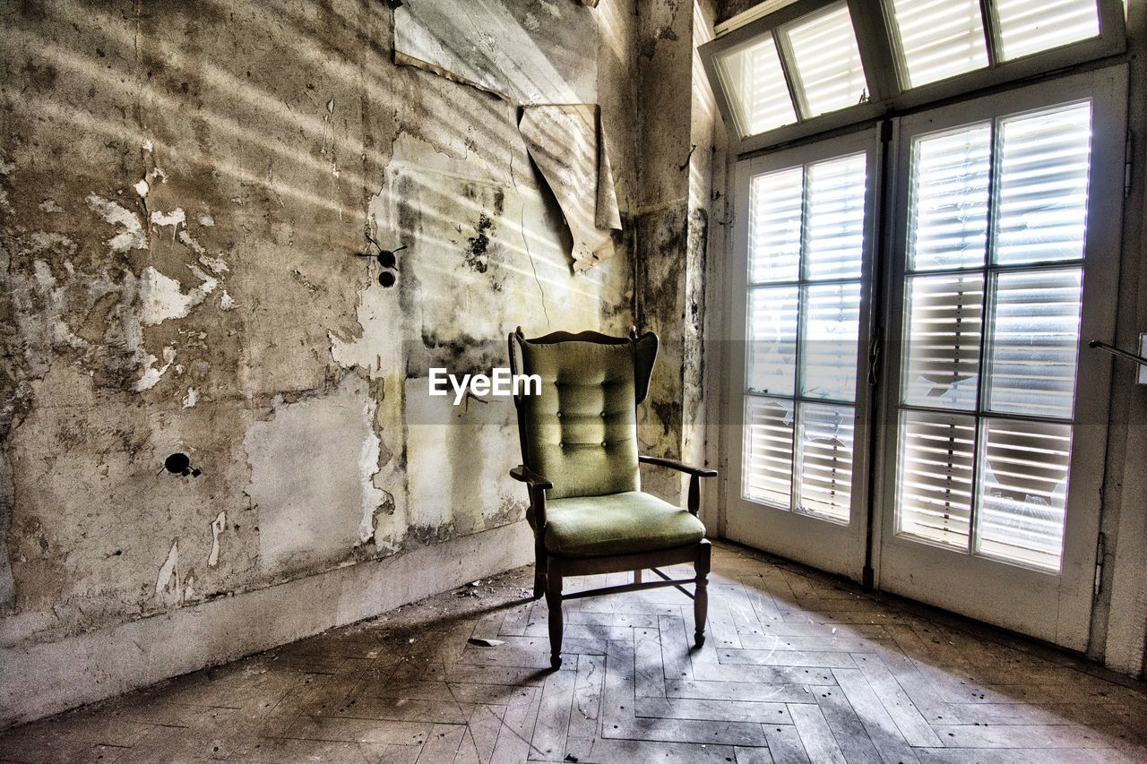 Empty chair in abandoned building