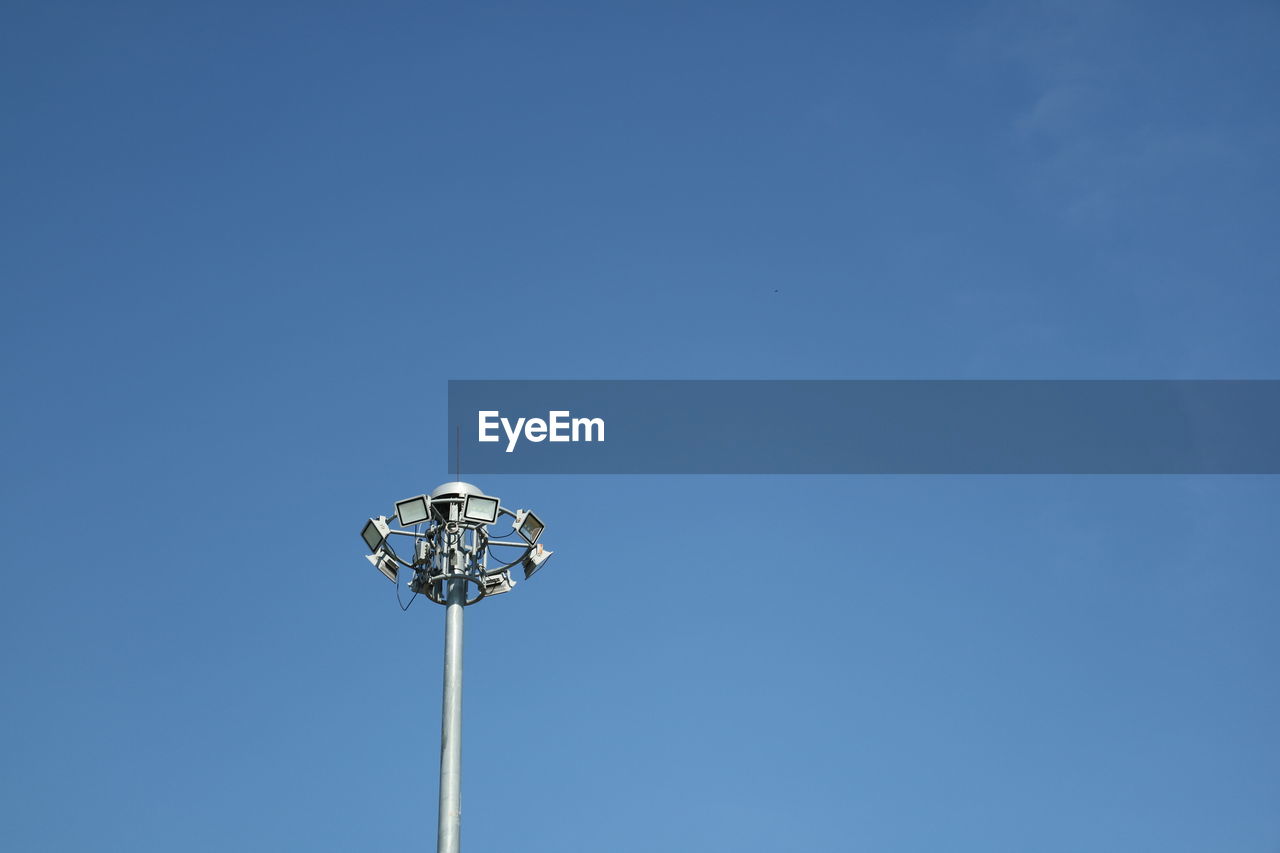 Low angle view of floodlight against clear blue sky