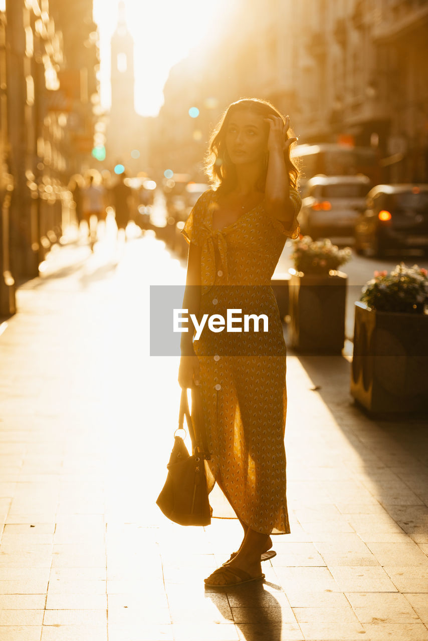 rear view of woman standing in city