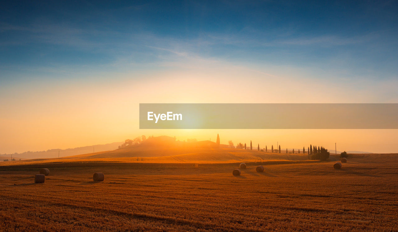 scenic view of landscape against sky during sunset