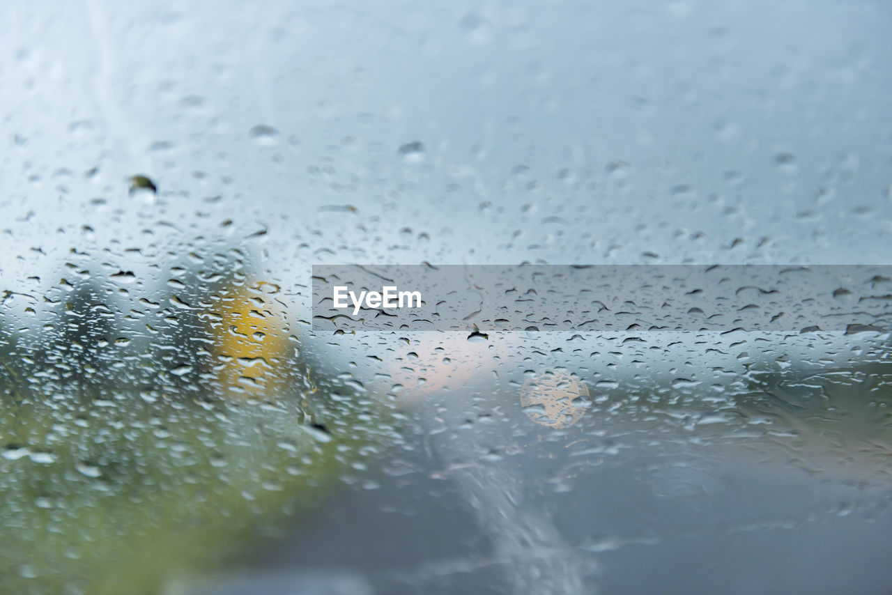 Rain drops on car windshield.