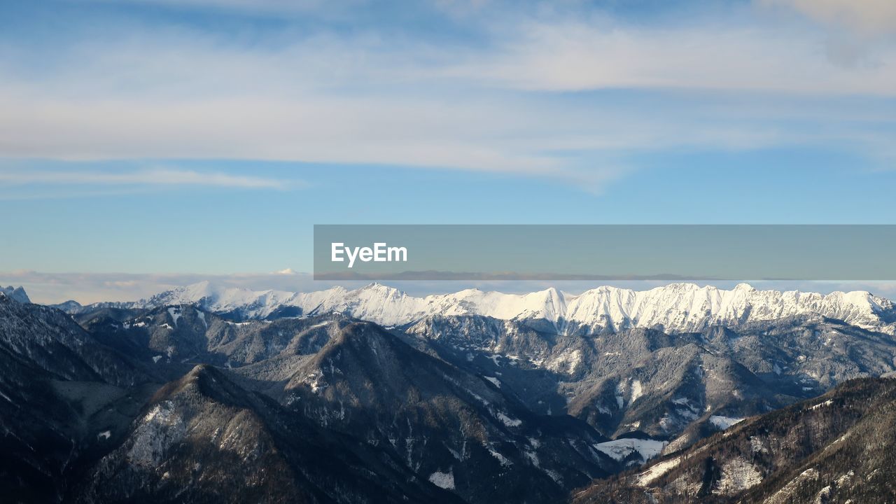 Scenic view of snowcapped mountains against sky