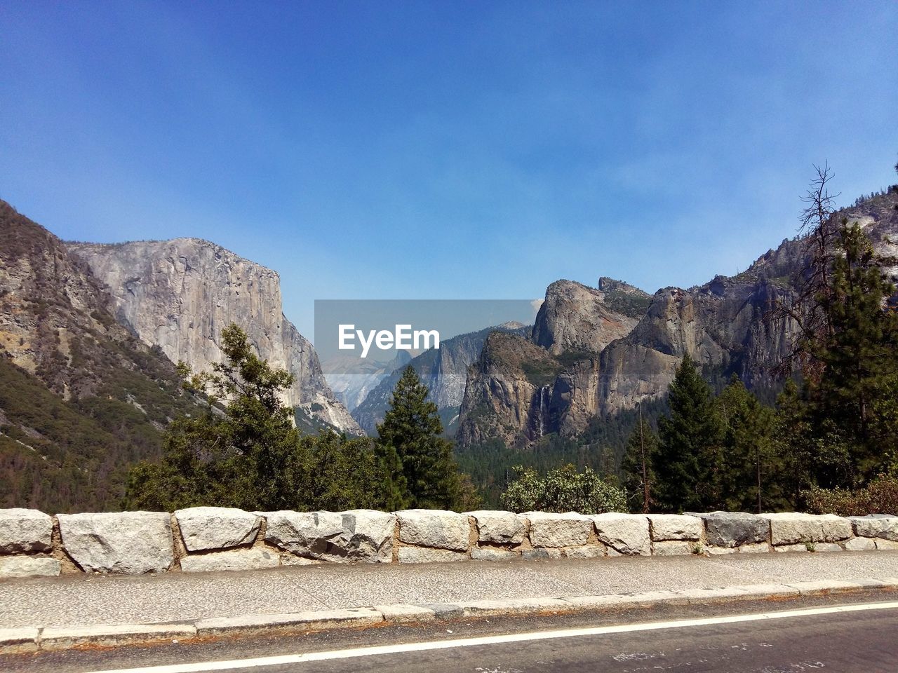 Scenic view of mountains against clear blue sky