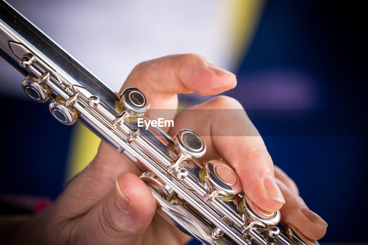 Close-up of hands playing musical instrument