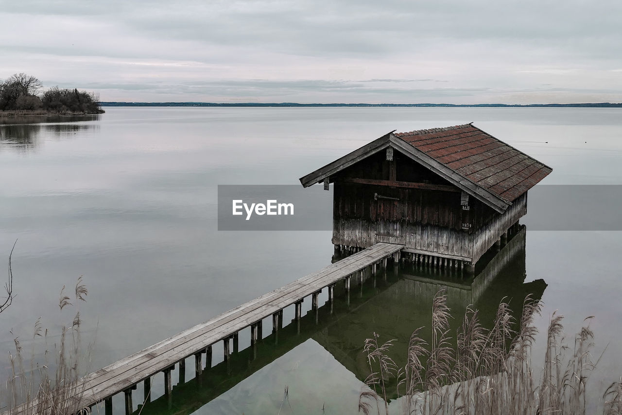 Scenic view at a boathouse on the mirrorlike chiemsee, bavarian  alpine lake 