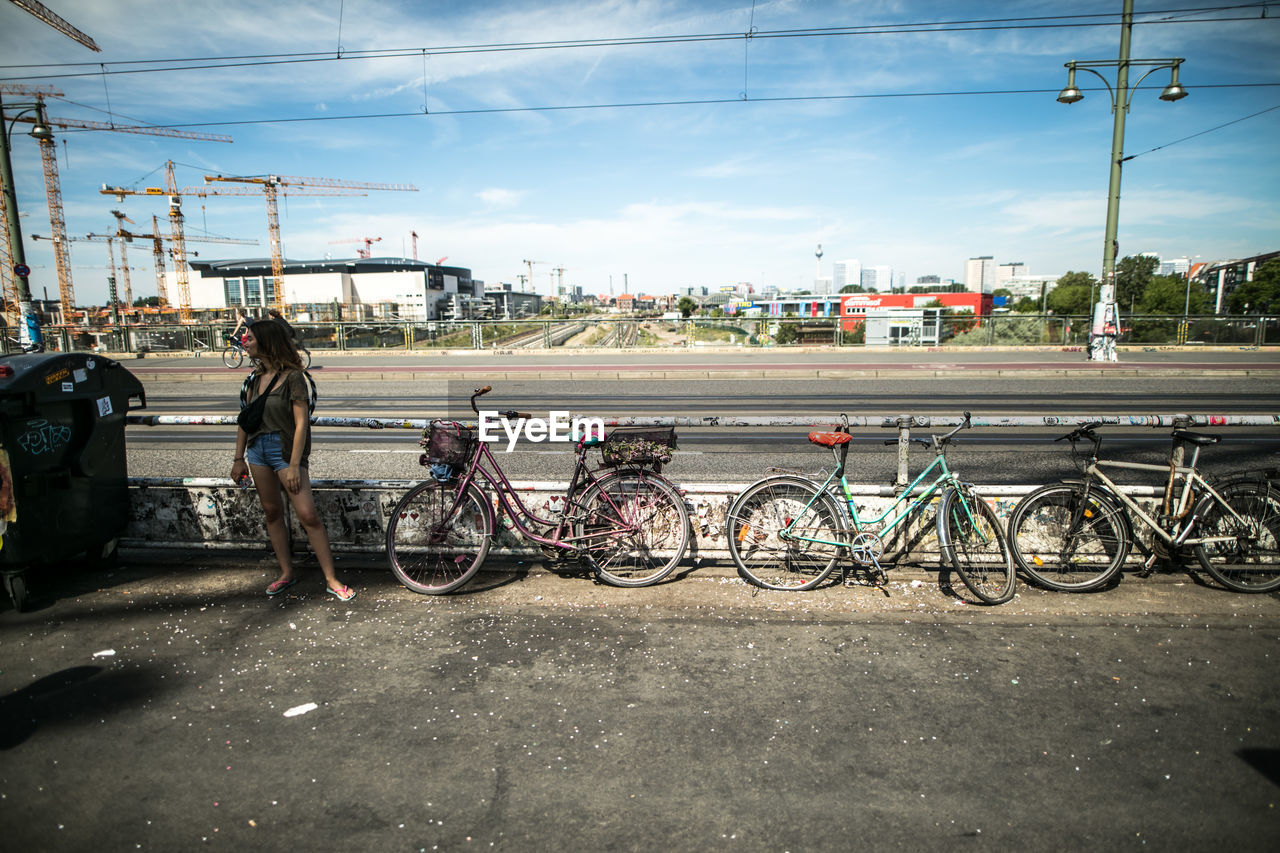BICYCLES PARKED ON ROAD AGAINST SKY