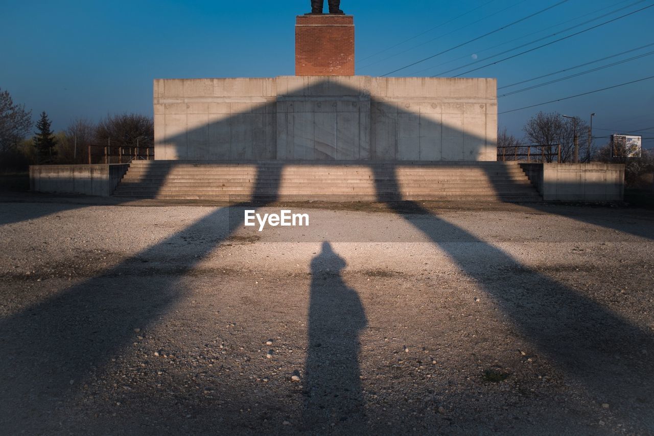 Shadow of built structure against blue sky