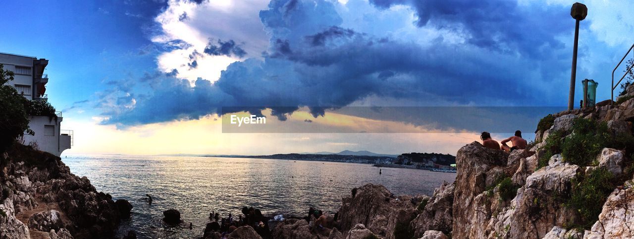 Idyllic shot of sea by rocks against sky at coco beach