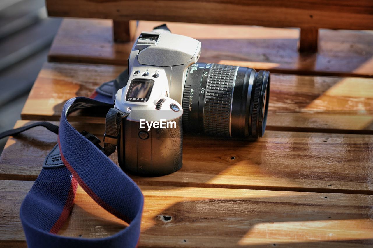 HIGH ANGLE VIEW OF CAMERA AND TABLE