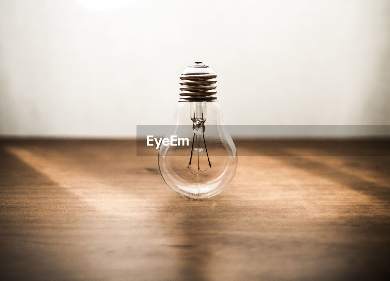 Light bulb on wooden table