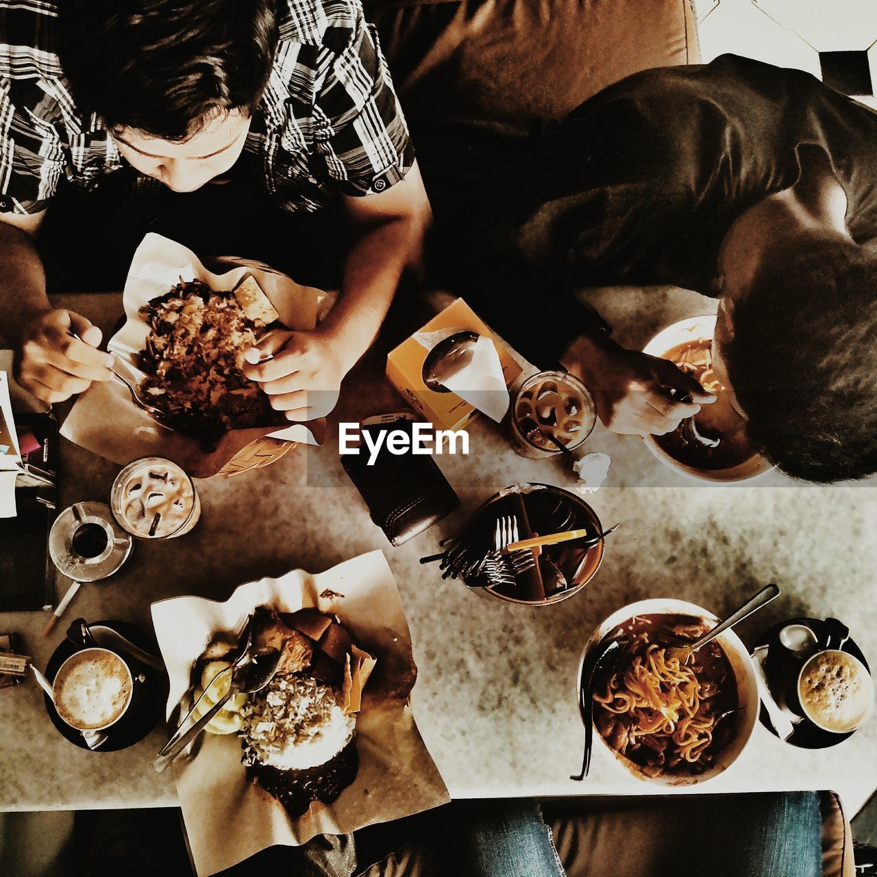 High angle view of men eating at restaurant