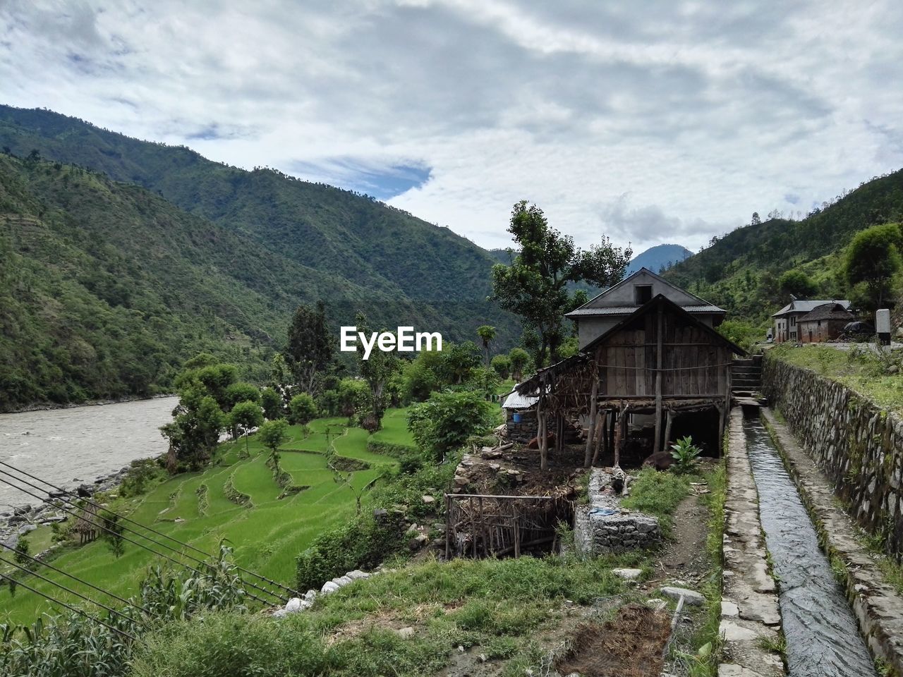 Scenic view of mountains against cloudy sky