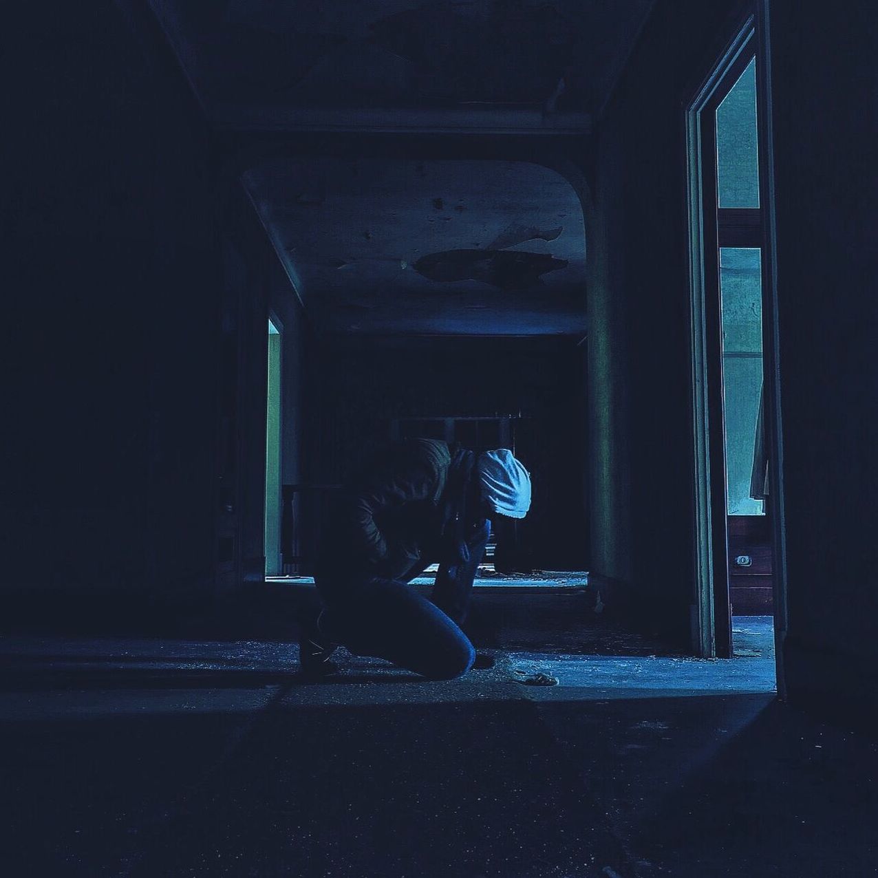 Man kneeling in abandoned house