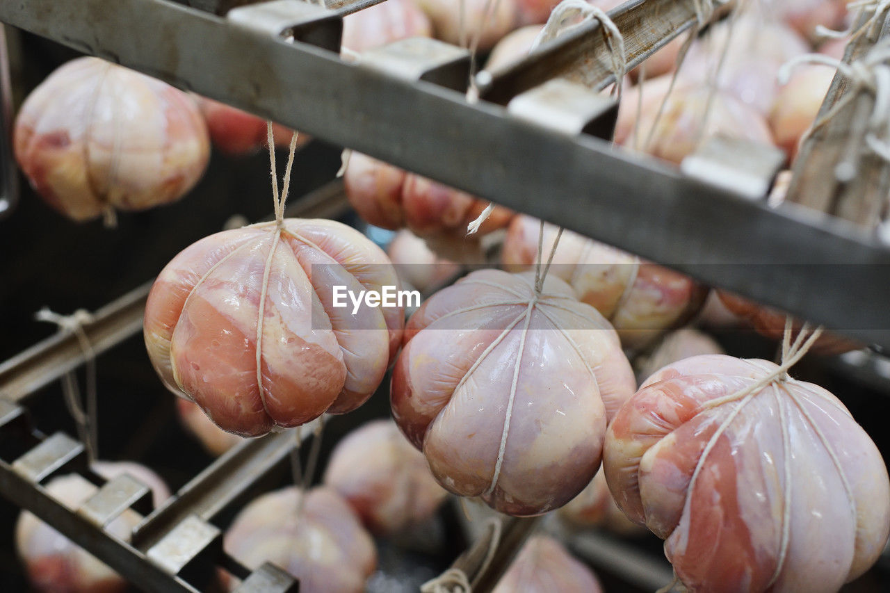food, food and drink, freshness, meat, hanging, no people, dish, healthy eating, retail, market, business finance and industry, produce, wellbeing, focus on foreground, close-up, business, outdoors, shallot, day, abundance, vegetable, selective focus
