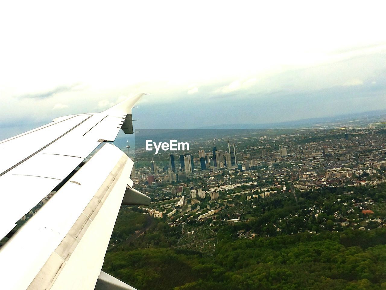 LOW ANGLE VIEW OF AIRPLANE FLYING OVER LANDSCAPE