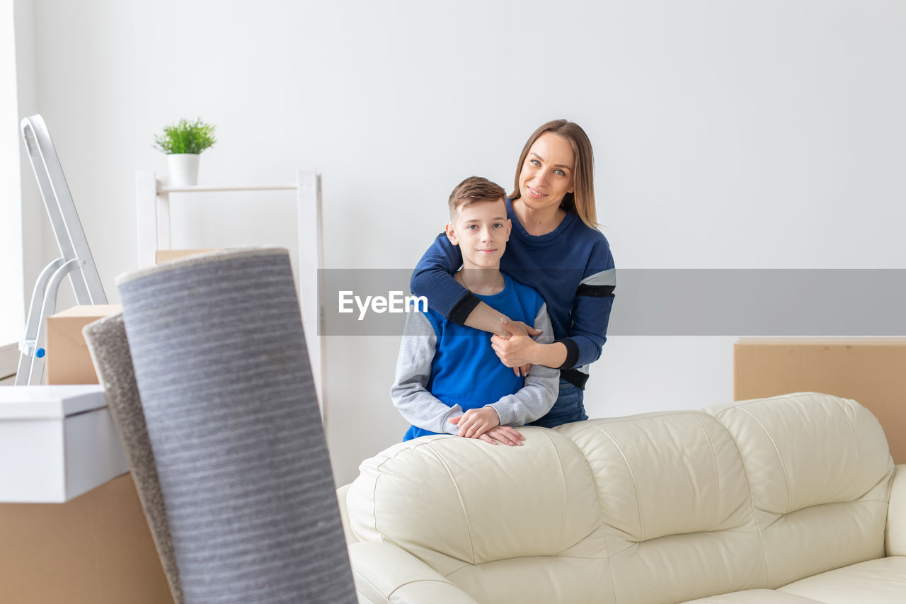 Friends sitting on sofa at home