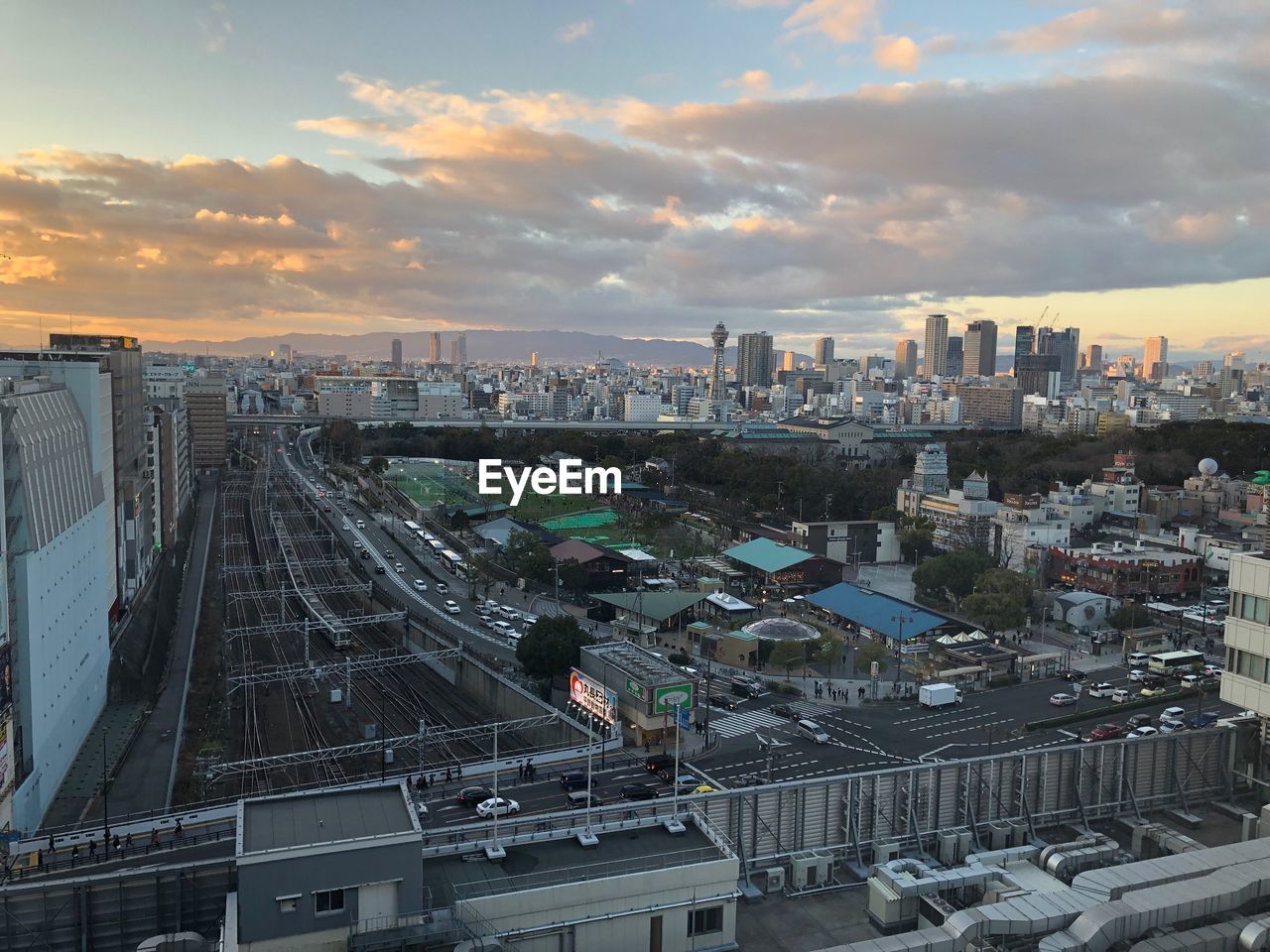 HIGH ANGLE VIEW OF ROAD AMIDST BUILDINGS IN CITY