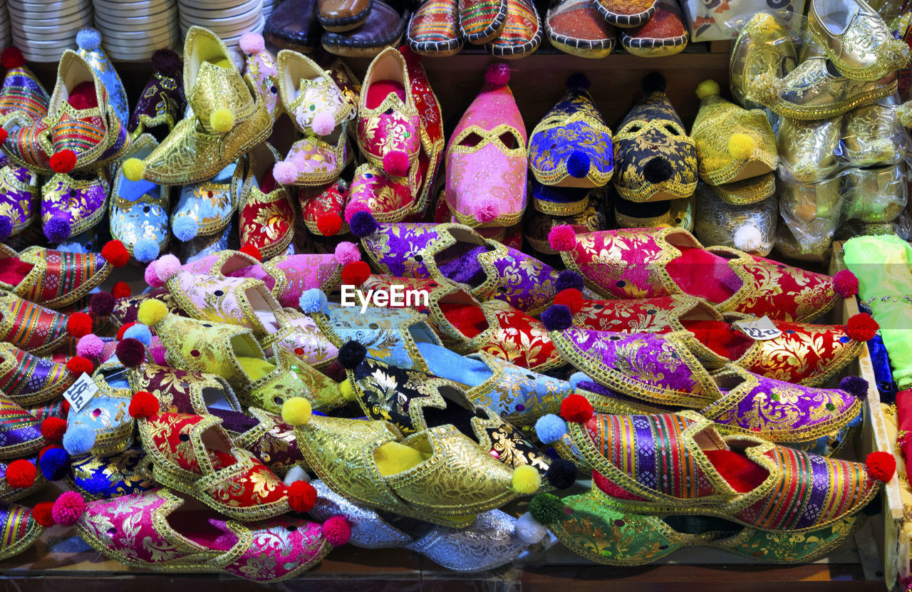 High angle view of traditional shoes at market stall for sale