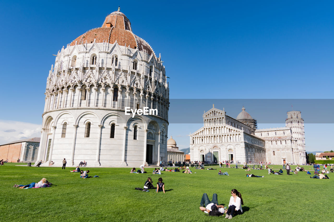 People at piazza dei miracoli against sky