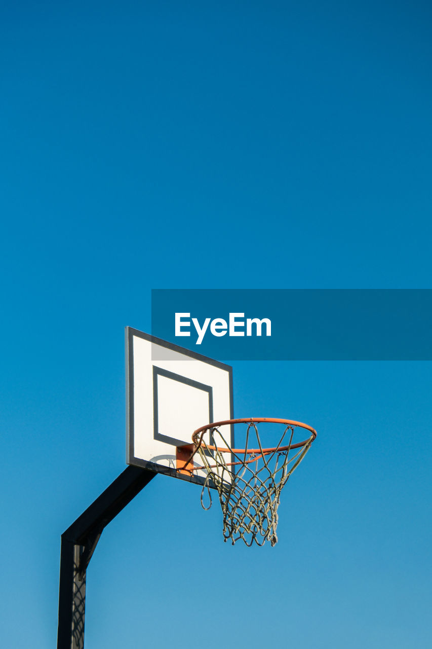 low angle view of basketball hoop against blue sky