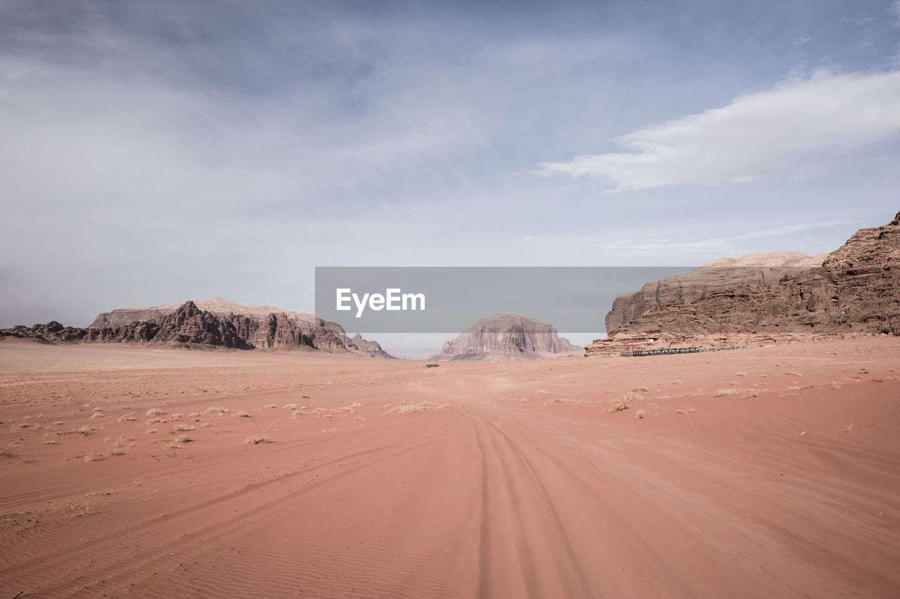 Sand dunes in desert against sky