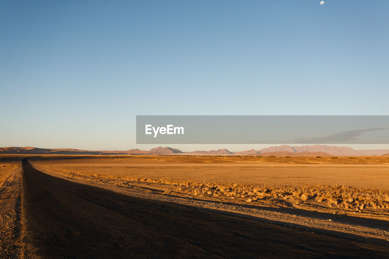 Scenic view of desert against clear sky