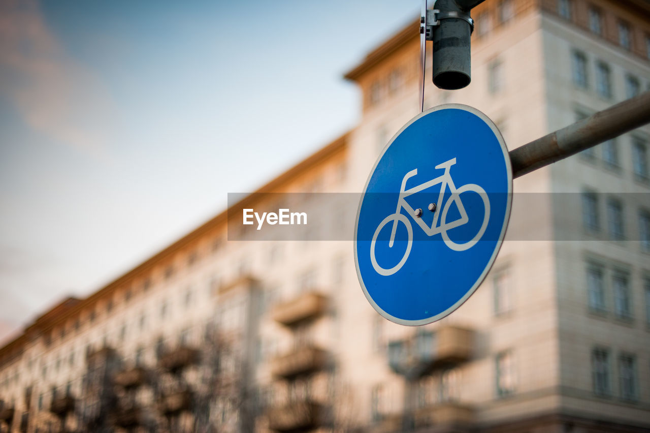 Low angle view of road sign against building in city