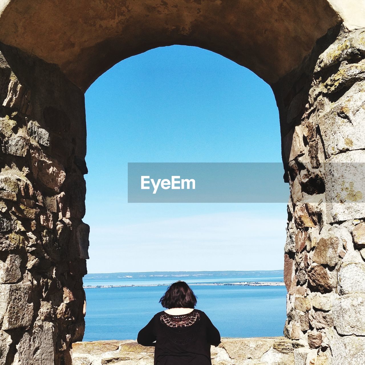 Rear view of woman looking at sea against sky